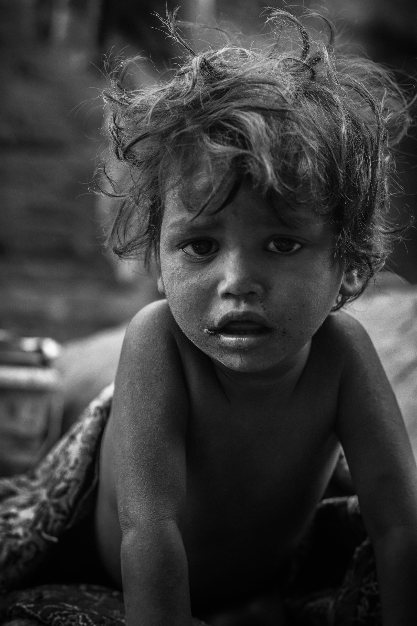 A moving black and white portrait capturing the emotional depth of a young child.
